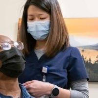 Parker spine specialist Dr. Esther Yoon examines a patient who is considering ACDF to treat her neck pain.