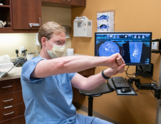 Denver spine surgeon Josh Beckman explaining how scoliosis affects the body.