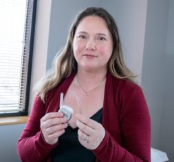 Heather, a Neurosurgery One patient, holds a spinal cord stimulator.