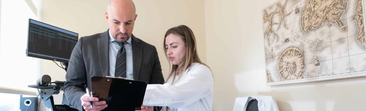 Physician assistant Katie Kalamula discusses a spine surgery case with Dr. Wissam Asfahani.