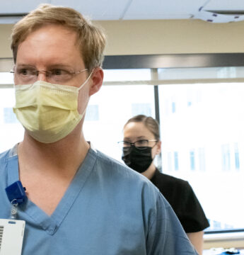 Dr. Beckman, spine surgeon at Neurosurgery One, prepares for TOPS procedure, a motion-preserving spinal surgery.
