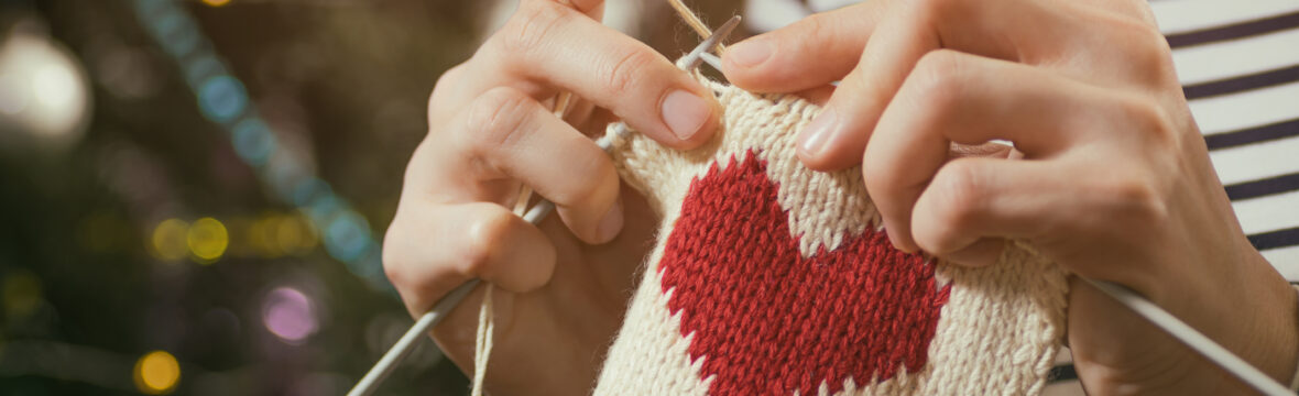 Hands knitting without pain a heart shape piece.