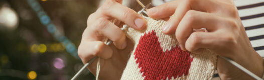 Hands knitting without pain a heart shape piece.